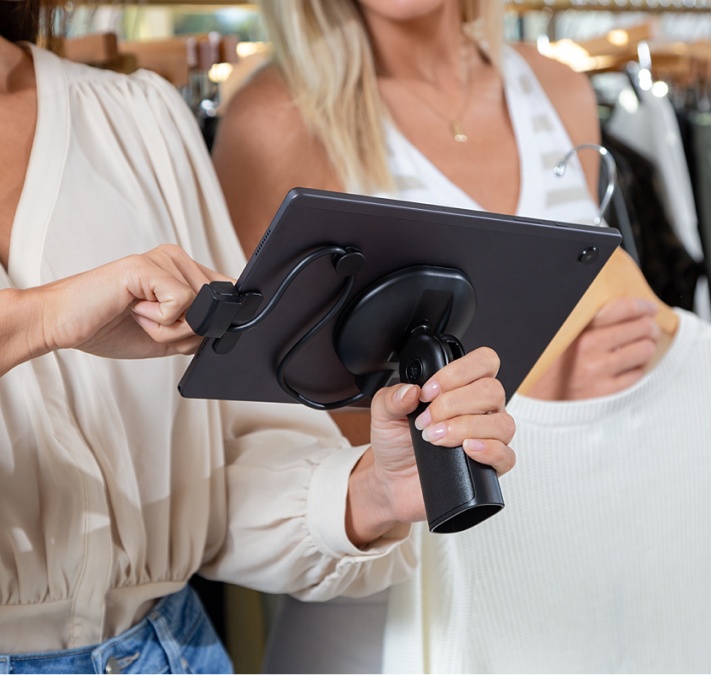 Dos mujeres utilizan un TPV móvil en un comercio minorista.