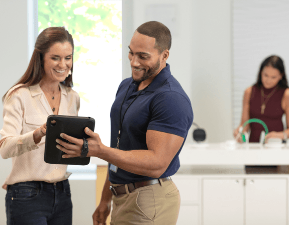 Hombre y mujer mirando una solución mPOS en un comercio minorista