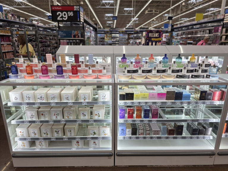 una vitrina de cristal en la que se exponen las cajas de perfume, con expositores de muestras situados en la parte superior para que el cliente pueda probar las fragancias.